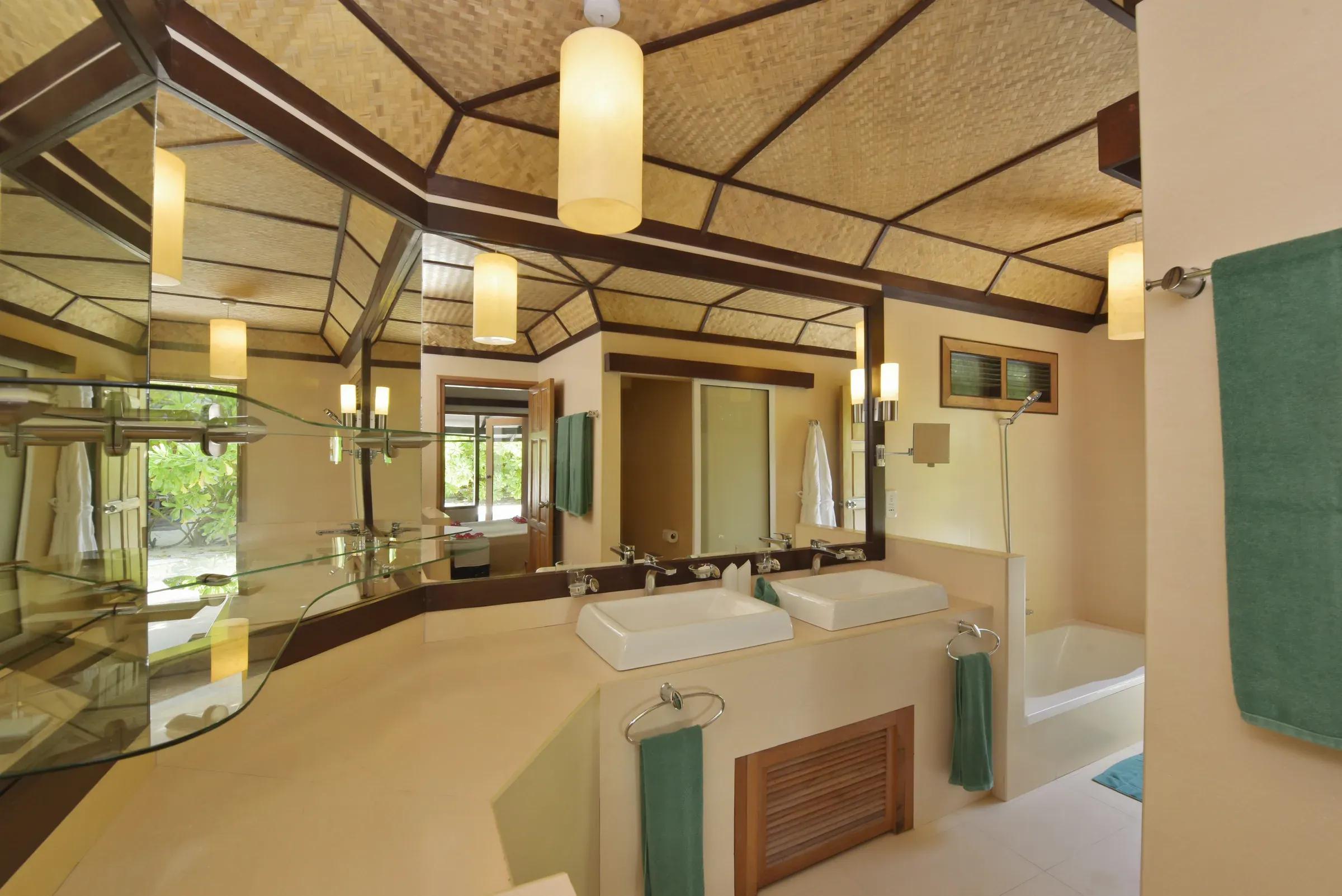 Bagno del SUPERIOR BEACH BUNGALOW con doppio lavabo e vasca al Angaga Island Resort & Spa.