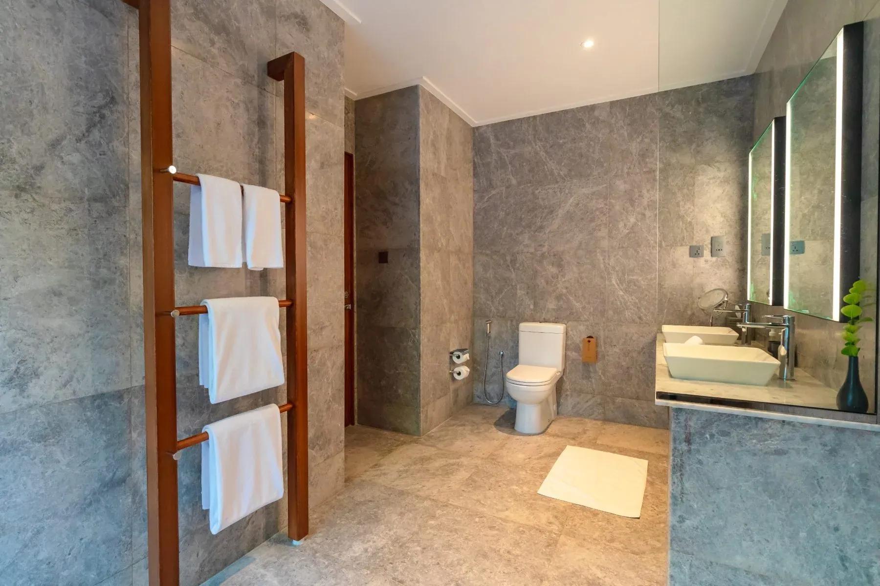 Bagno della Beach Pool Villa con lavabo doppio e portasciugamani in legno al Meeru Island Resort & Spa